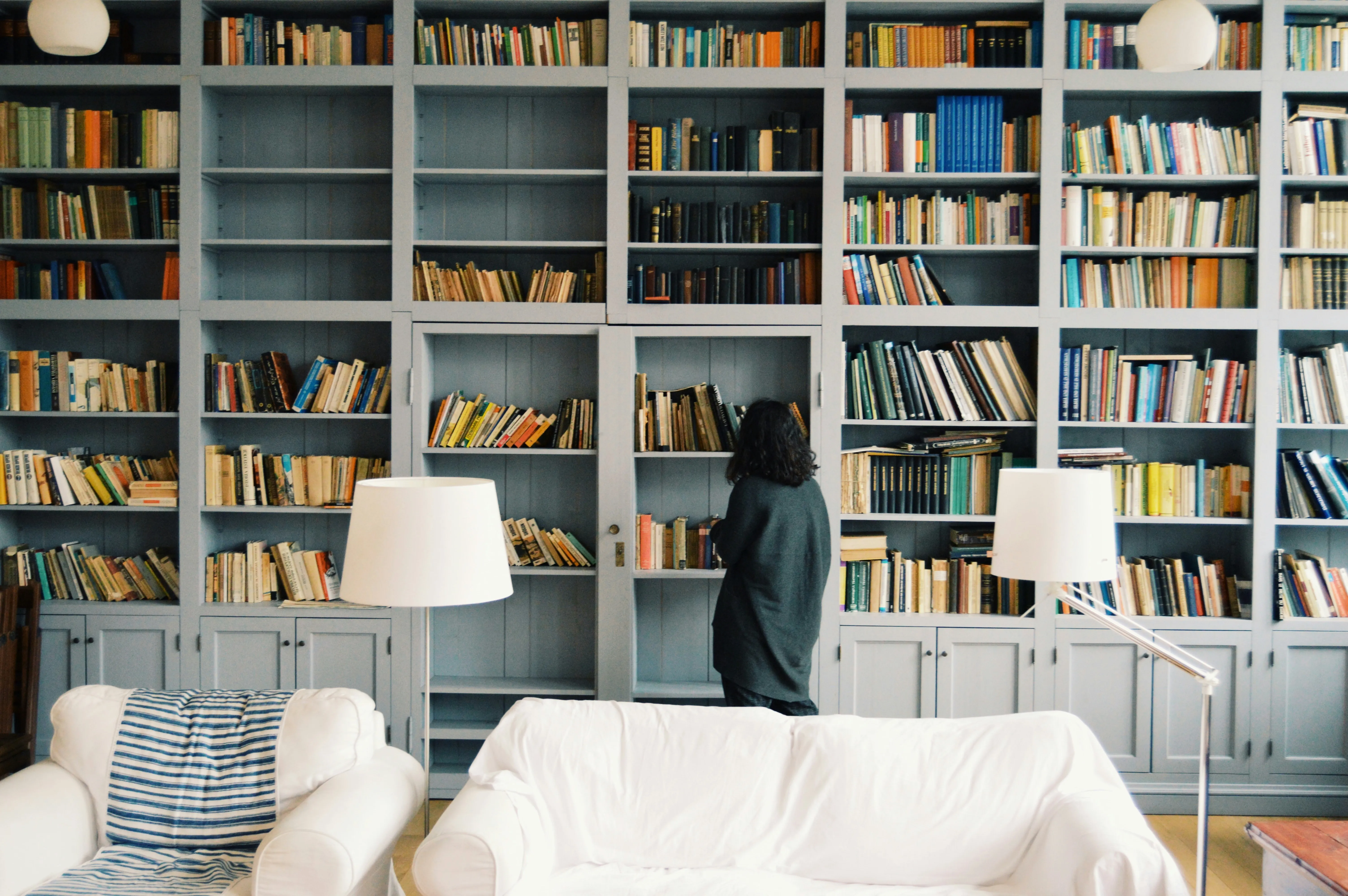 A raking-light photograph of the book spines on a shelf