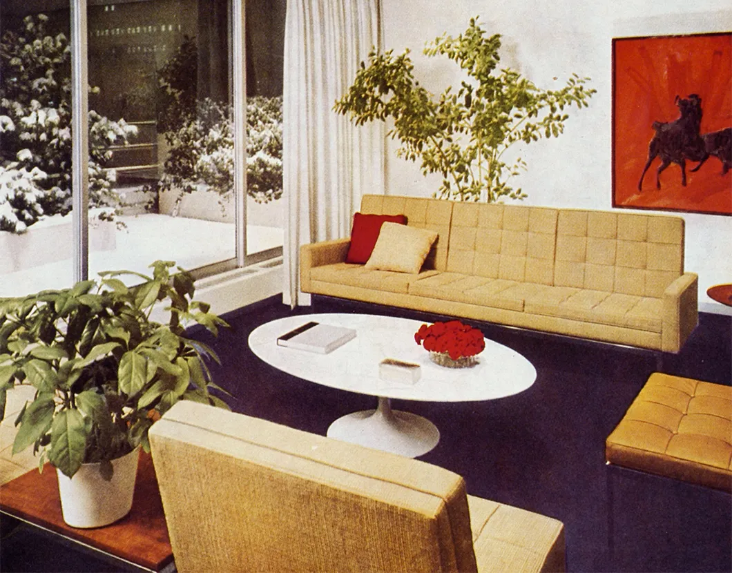 A classic mid-century interior, featuring the low, linear sofa designed by Florence Knoll in mustard.