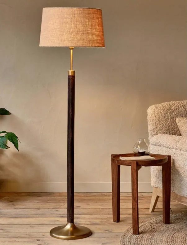 The Digha floor lamp — dark-stained wood and antique brass details