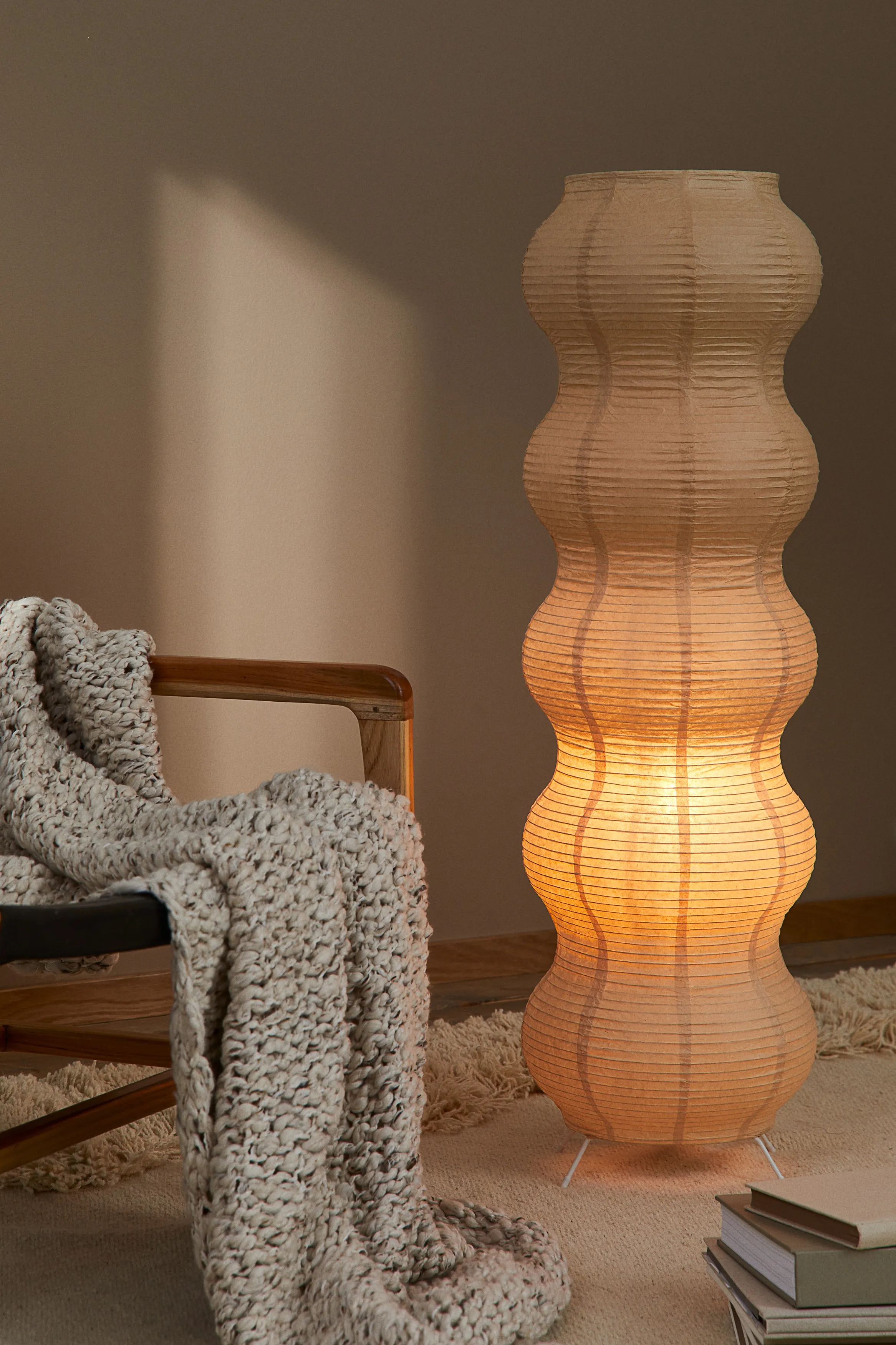 The H&M rice paper floor lamp — a simple white globe shade on a slim stem