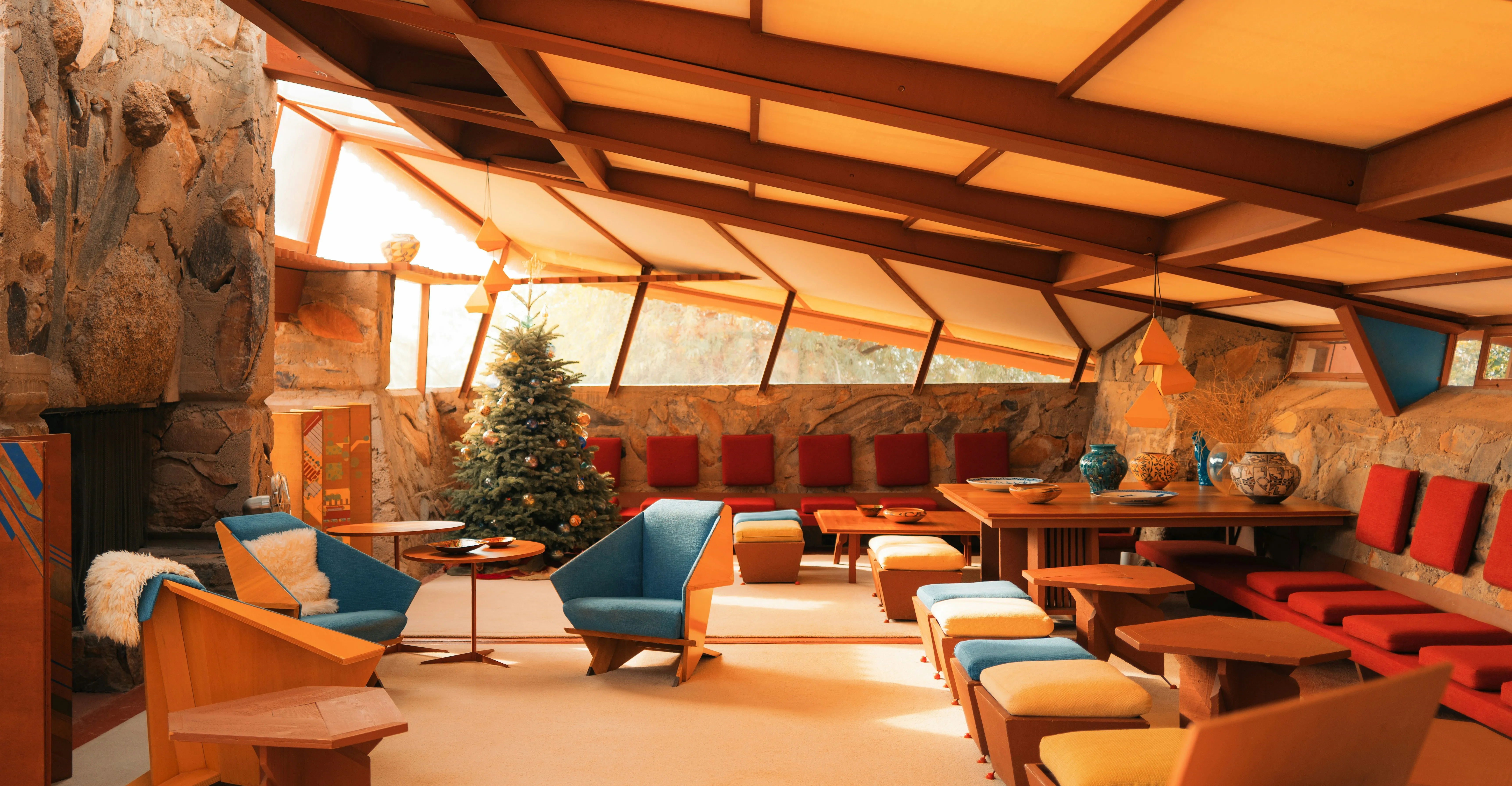 A classically mid-century modern room with warm wood walls and bold furniture