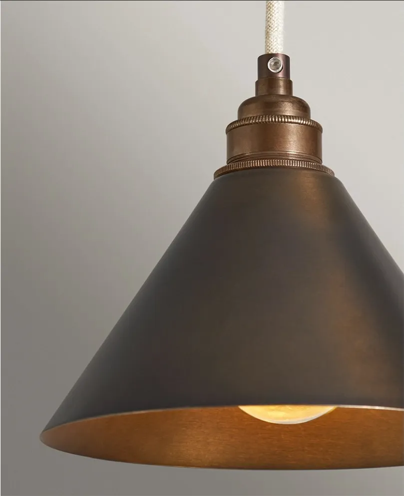 Dowsing & Reynolds antique-brass metal cone pendant over a kitchen island