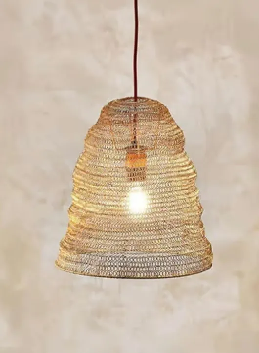 Nkuku Jatani antique-brass wire lampshade over a worktop