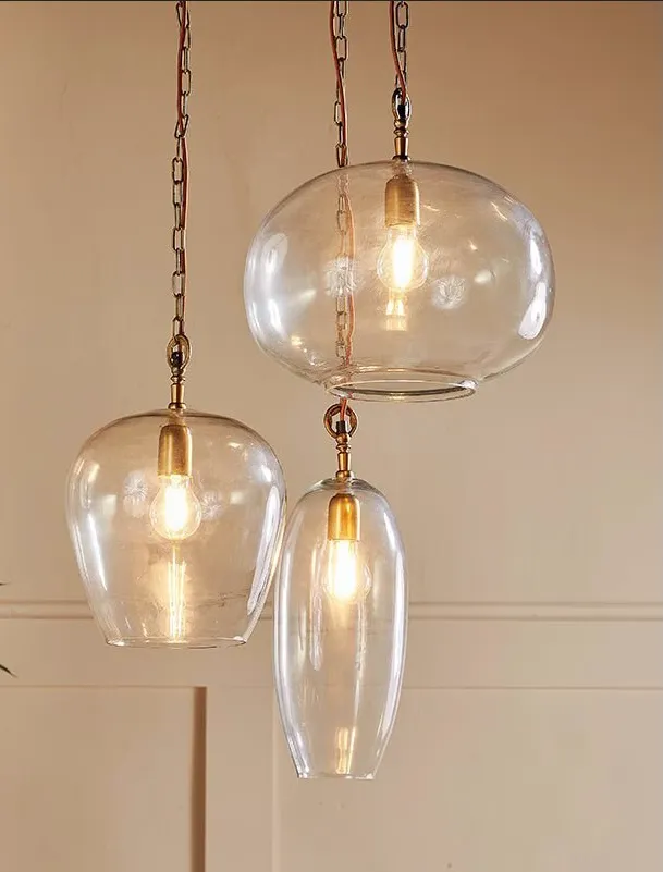 PLACEHOLDER — Nkuku Otoro recycled-glass cluster pendant over a large island