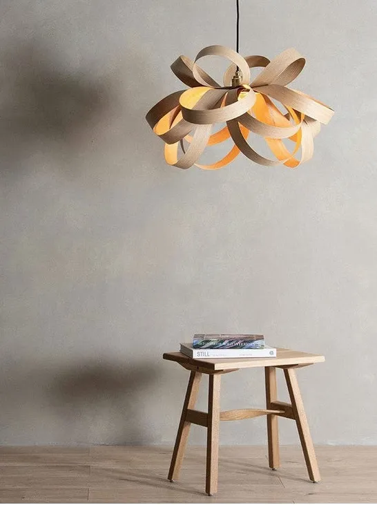 PLACEHOLDER — Tom Raffield Skipper steam-bent wood pendant in walnut over a dining table